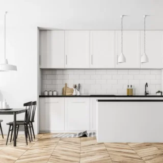 Modern white kitchen with custom cabinetry, subway tile backsplash, and island showcasing a completed kitchen renovation