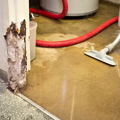 Standing water on basement floor during emergency water damage restoration and water extraction service