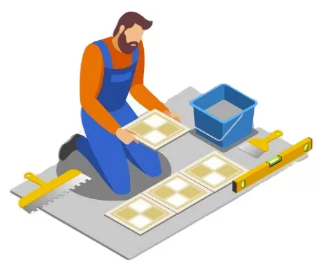 Professional tile installer laying ceramic floor tiles with leveling tools during a flooring installation project