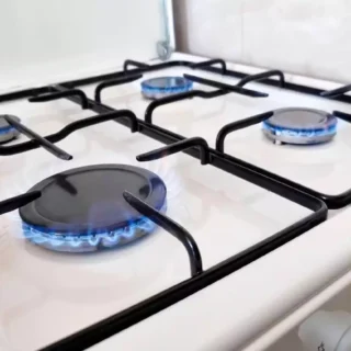 Gas cooktop with blue burner flames representing professional gas stove repair and gas appliance services