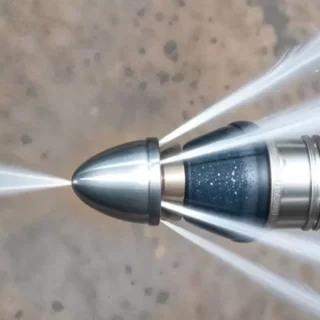 Hydro jetting nozzle cleaning a clogged sewer line with high-pressure water for professional drain cleaning
