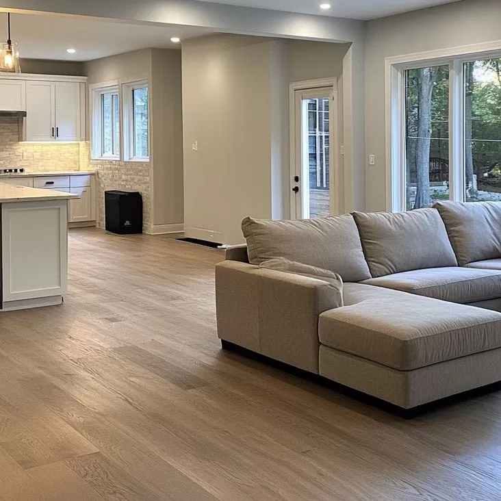Open-concept living room and kitchen remodeled with luxury vinyl plank flooring and modern finishes